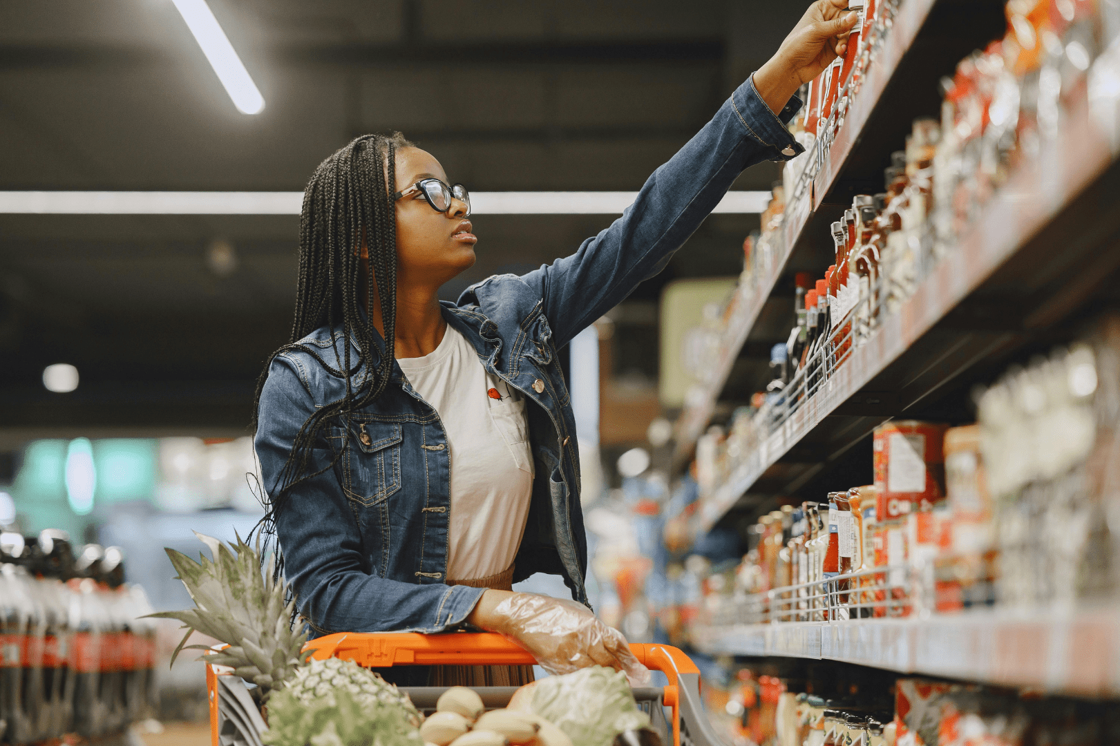 woman in a grocery store holding a food item